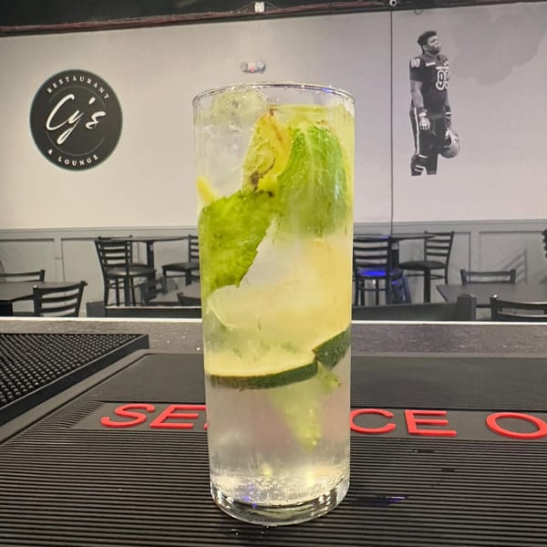 A refreshing mojito with lime and mint on a bar counter at Cy's Restaurant & Lounge.
